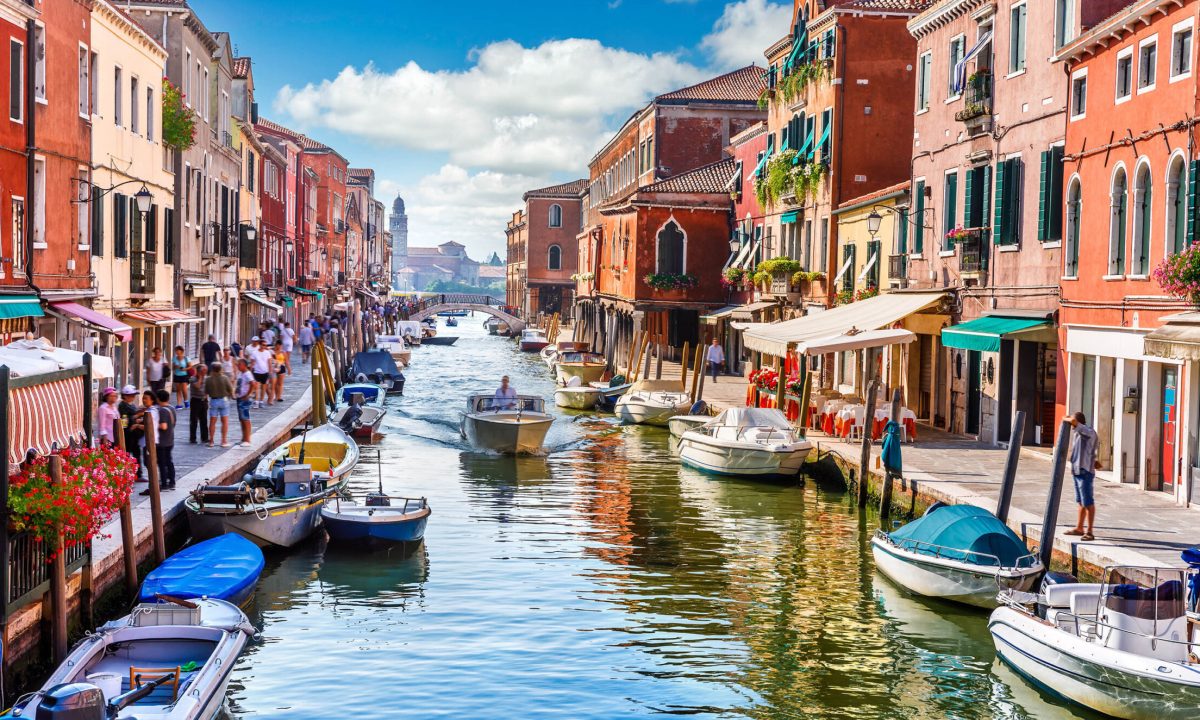 Island murano in Venice Italy. View on canal with boat and motorboat water. Picturesque landscape.