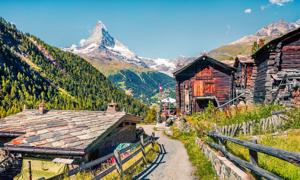 Sunny summer morning in Zermatt village with Matterhorn (Monte Cervino, Mont Cervin) peak on backgroud. Beautiful outdoor scene in  Swiss Alps, Valais canton, Switzerland, Europe.